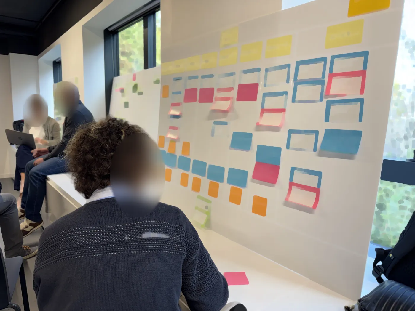 A colourful board seen from the side, a participant from behind